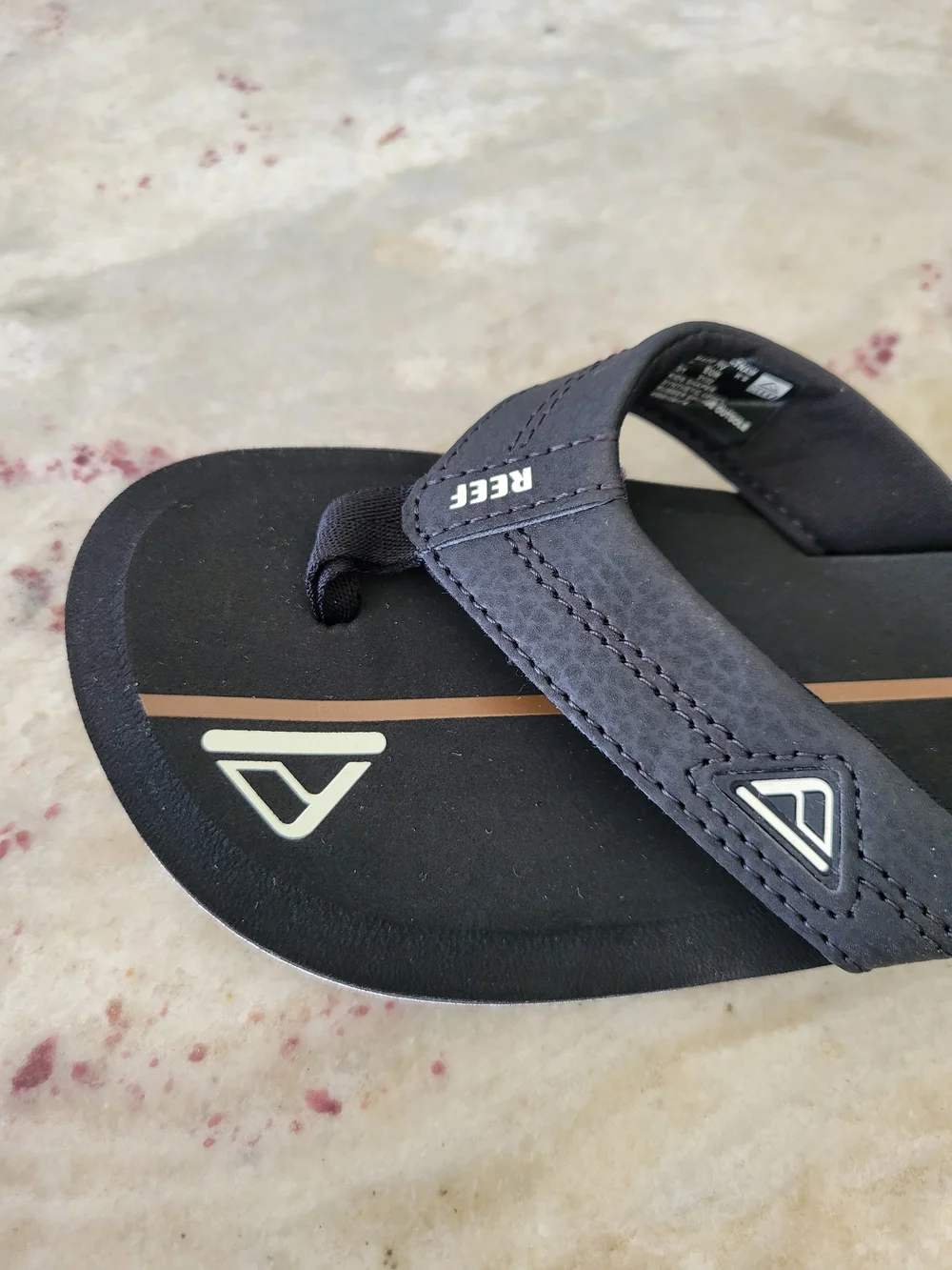 REEF Kid's Black With A Brown Stripe Logo Flip Flops